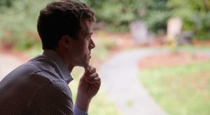 man silhouette at window thinking