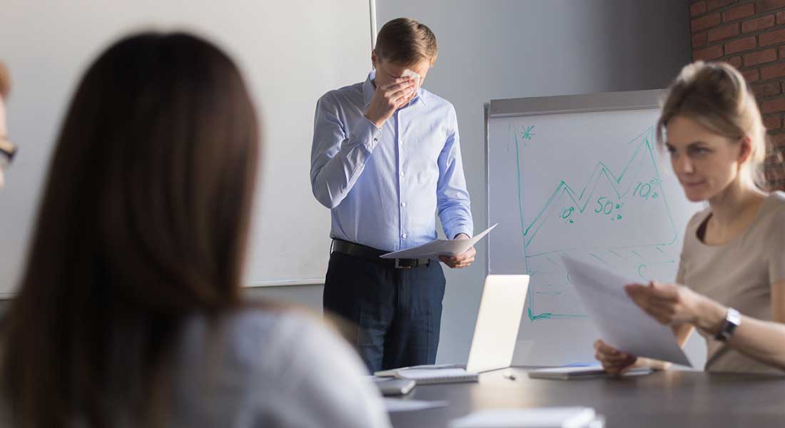 man experiencing distress while trying to give business presentation