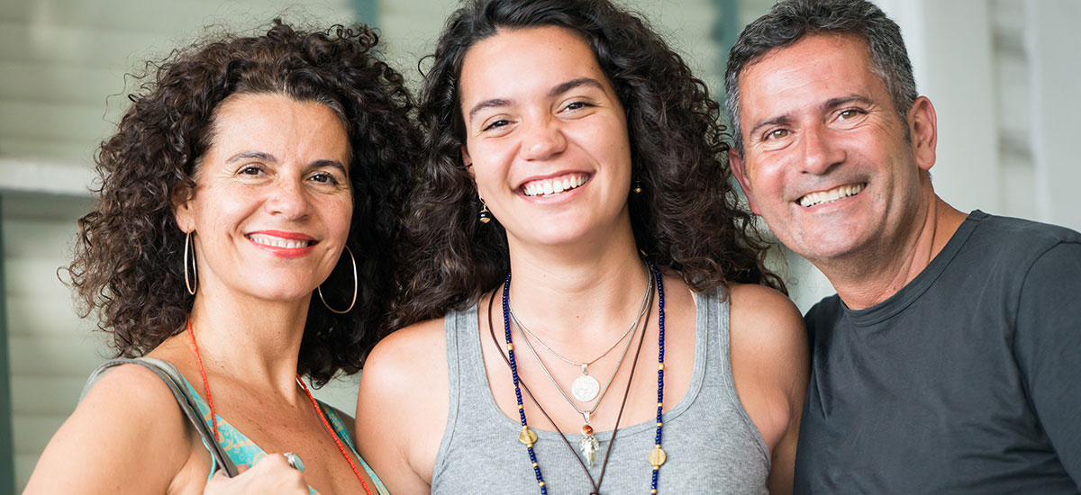 smiling teen with parents