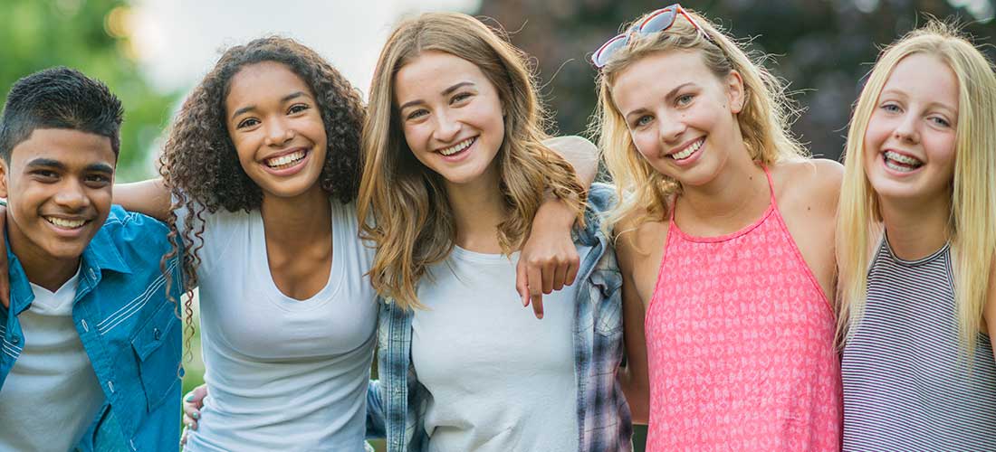 Adolescent Diagnoses five teens smiling at camera