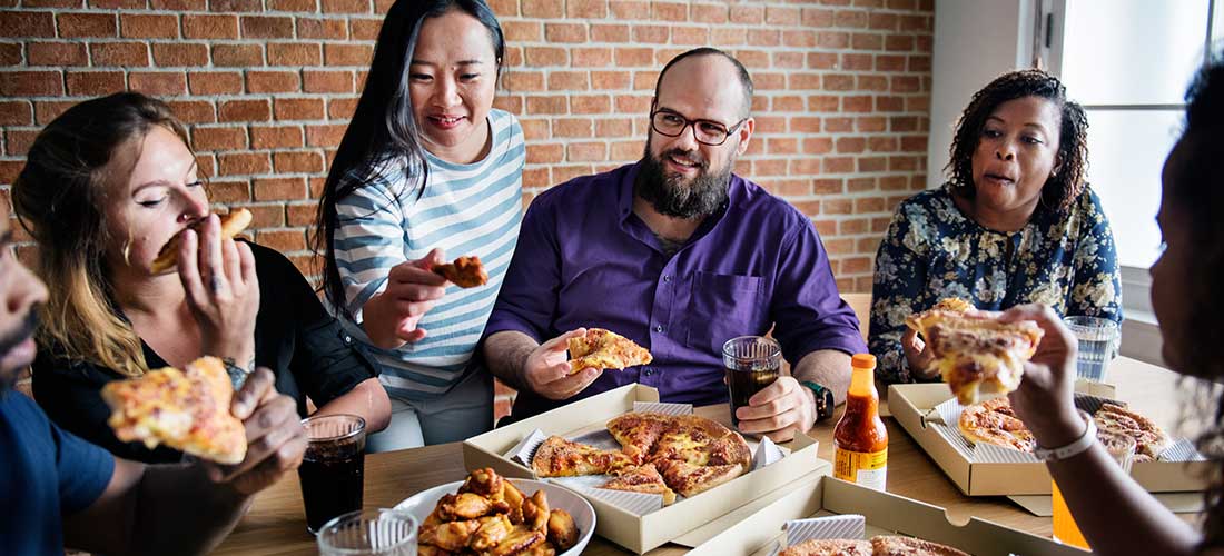 group of adults eating dinner together