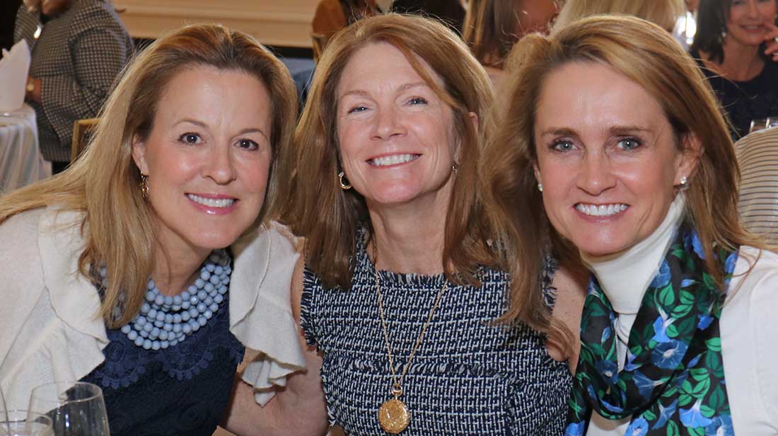 three women smiling at camera