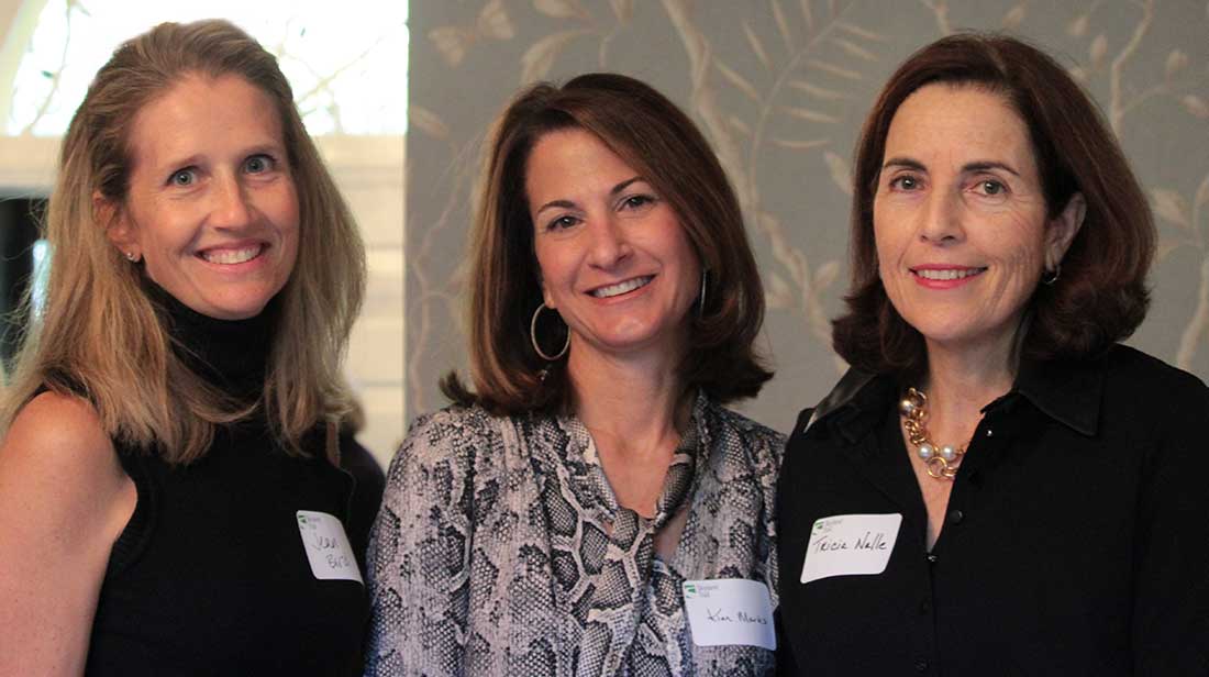 three women at a networking event