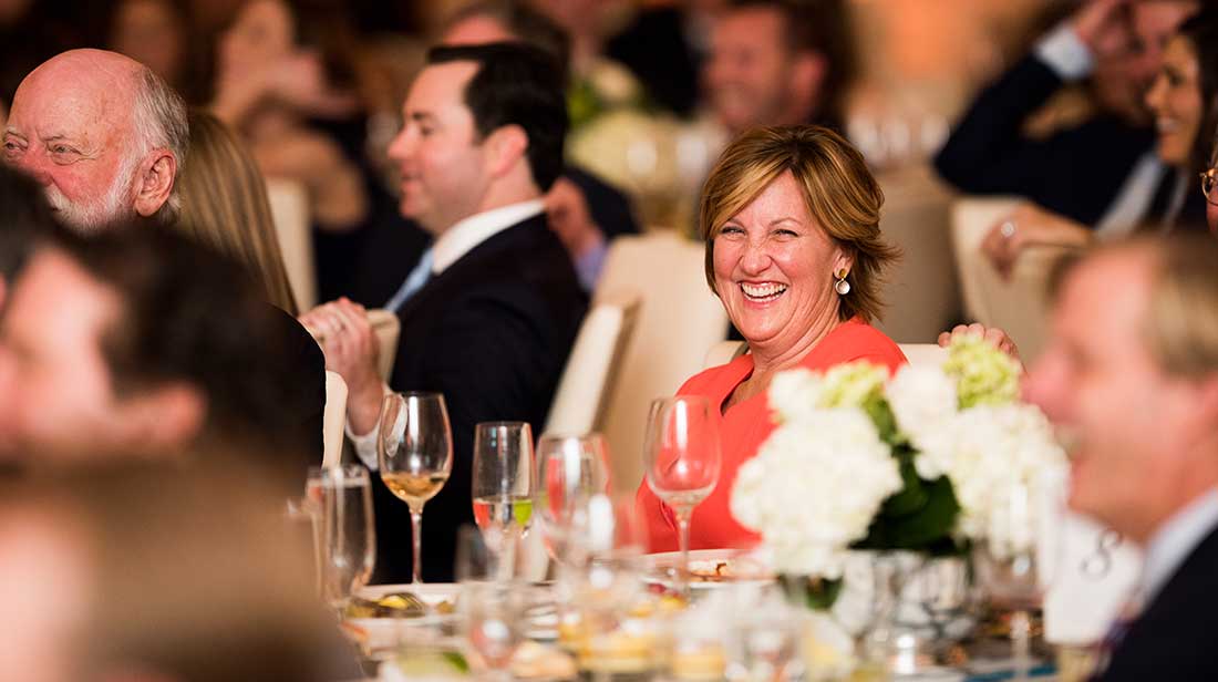 people at a table laughing
