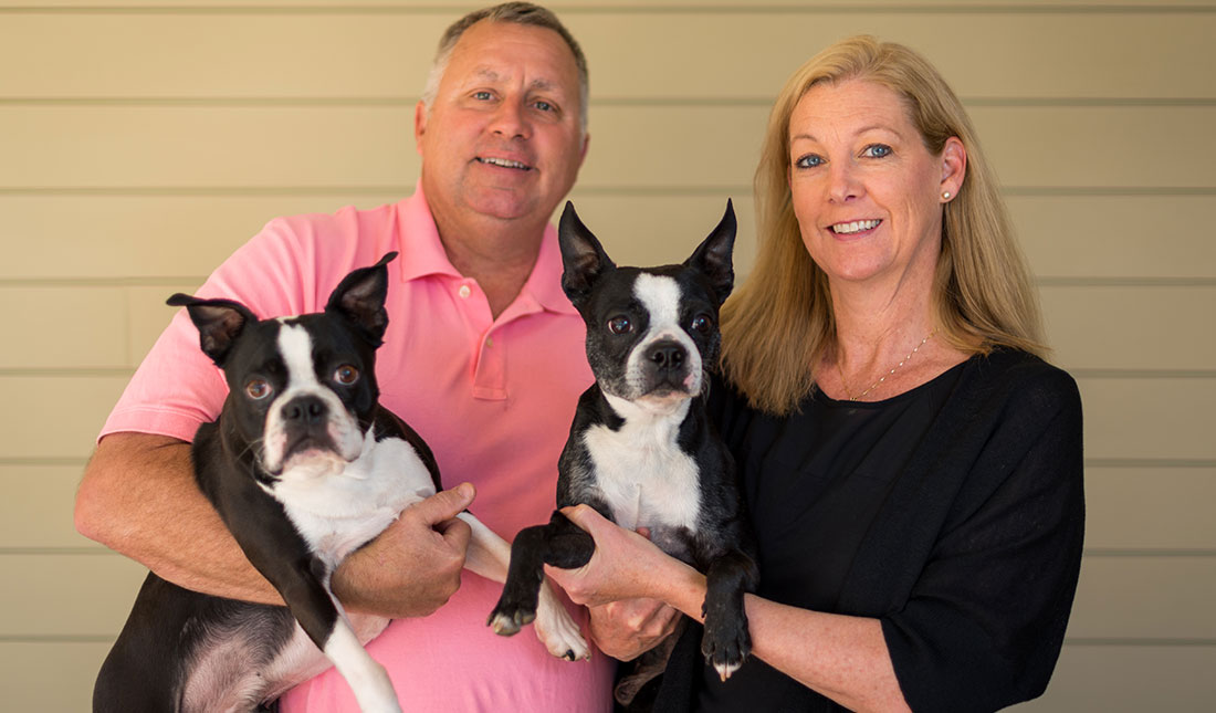 couple holding their dogs