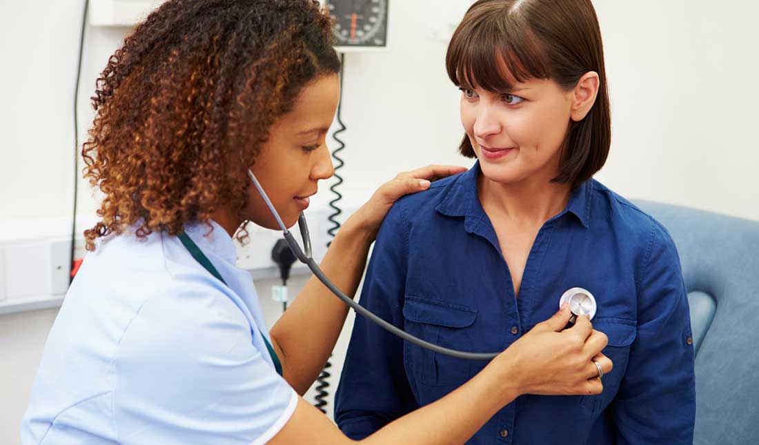 clinician using stethoscope on patient