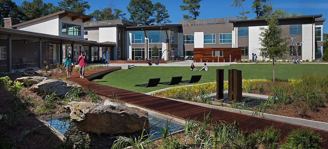 people walking on a boardwalk in the rollins campus courtyard