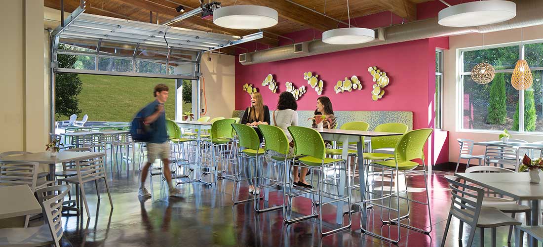 four young adults in dining hall