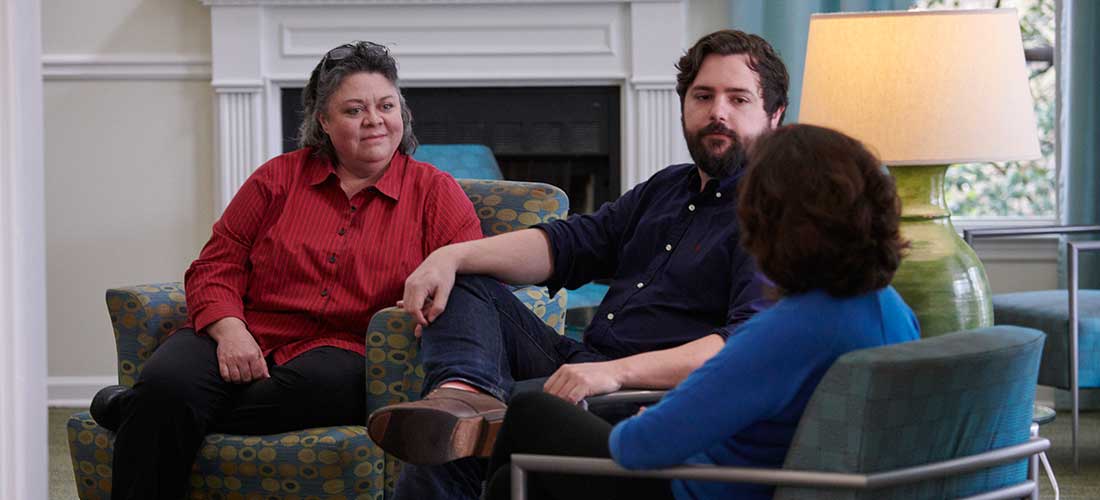 three people talking in the South common room