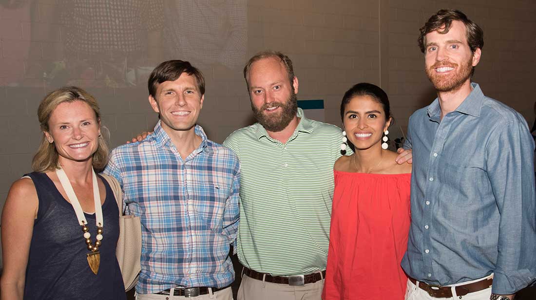 five young people smiling at camera