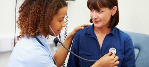 clinician using stethoscope on patient