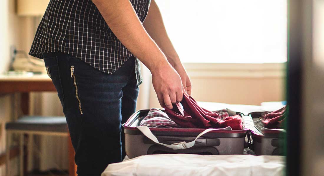 person packing a suitcase