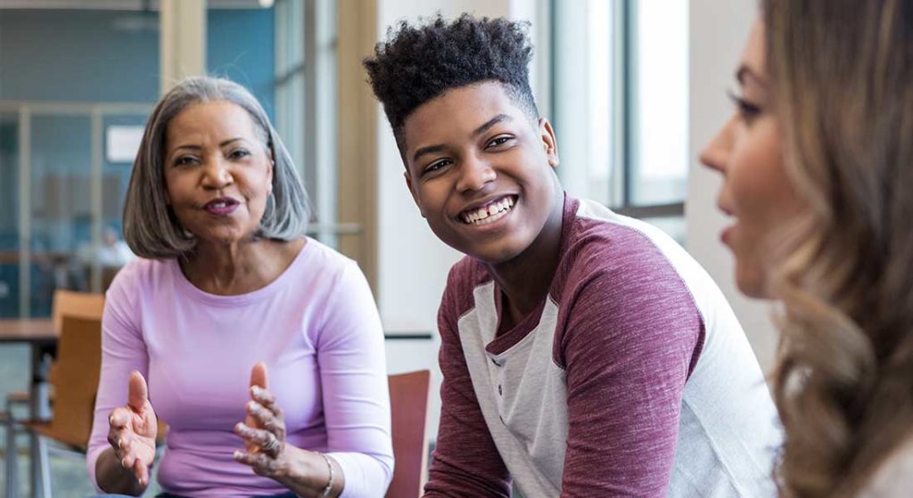 male teen participates in family therapy with mother