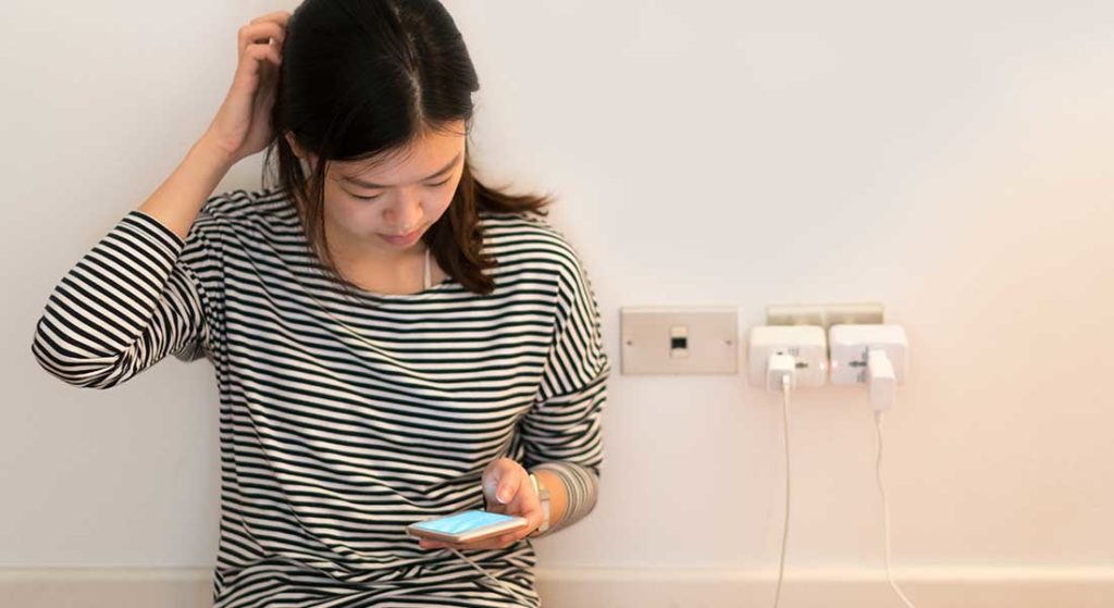 teen girl looking at cell phone