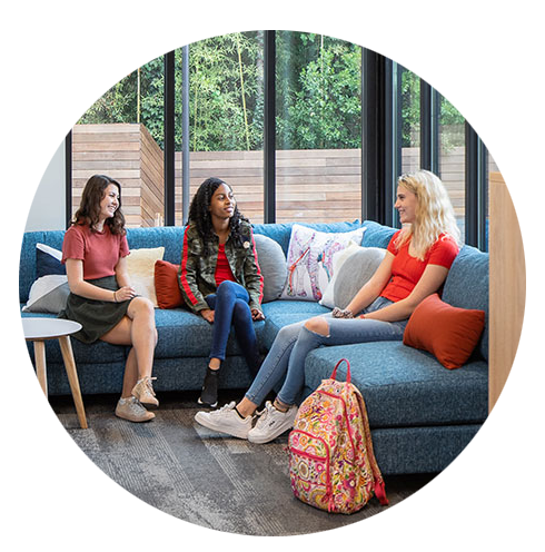 three teen girls sitting on a couch