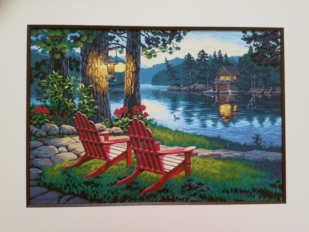 Acrylic painting of a sitting area on a lake a dusk