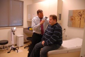 doctor performing patient exam in primary care clinic