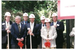 leaders wearing hard hats at HEC groundbreaking in 1998