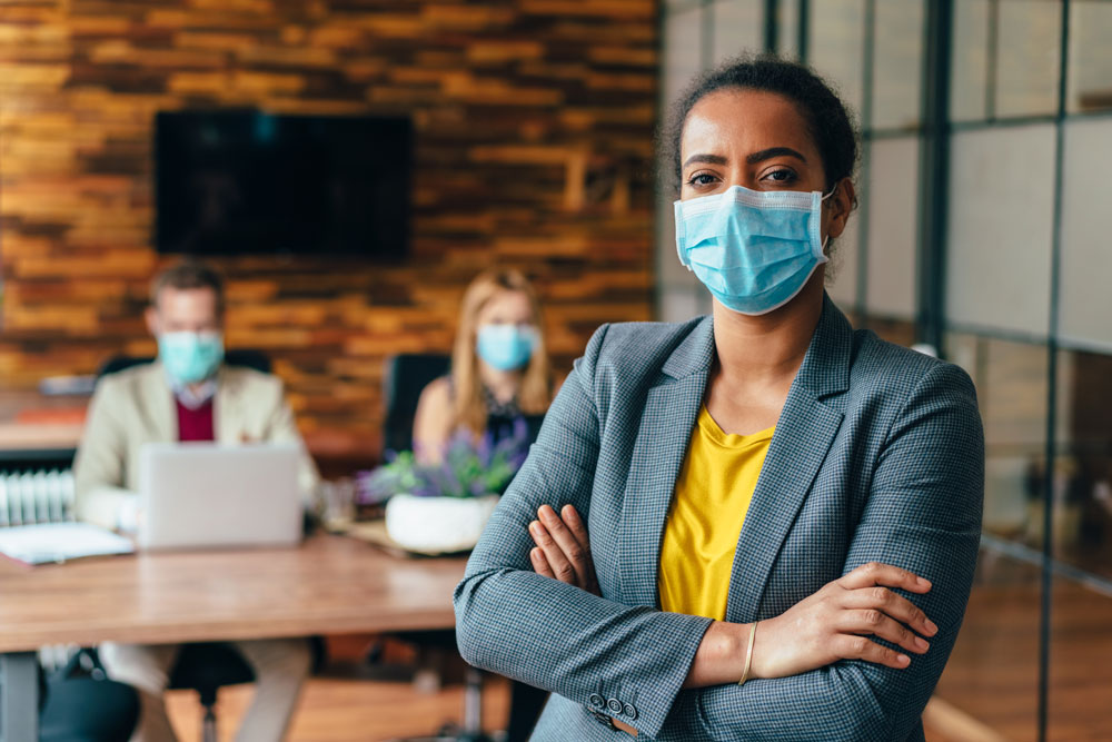 woman wearing mask in a business setting