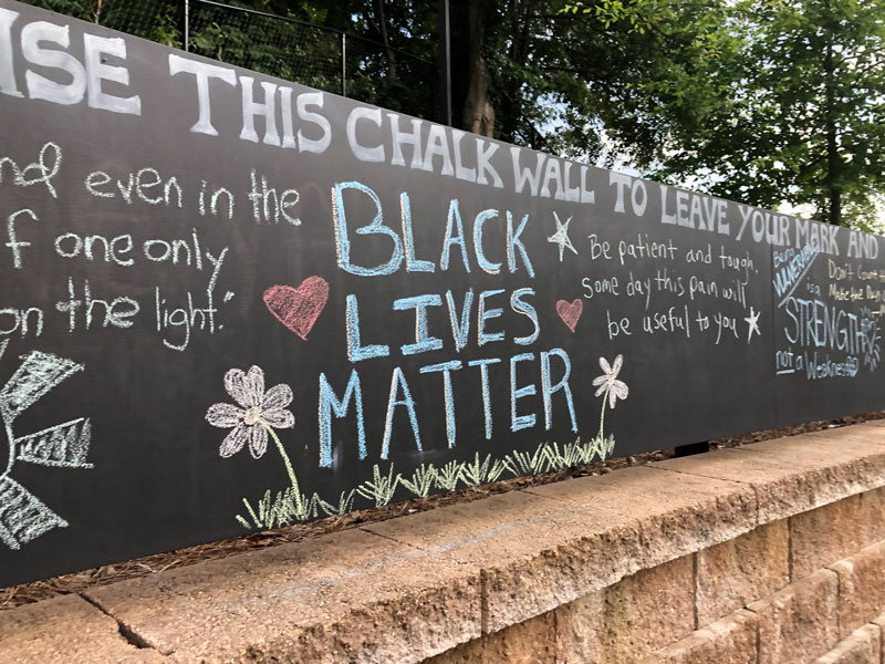 Black Lives Matter written on the chalk wall at Rollins Campus