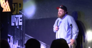 Comedian Aaron Weber on stage