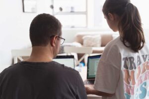 father helping teen daughter with her homework