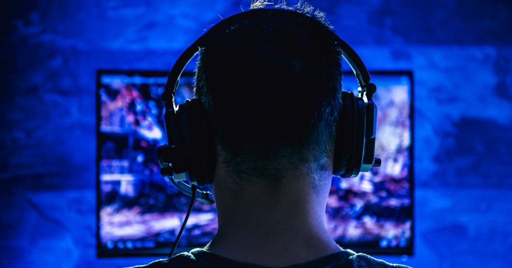 Digital Use Disorder Webinar a person wearing a headset playing video games in the dark