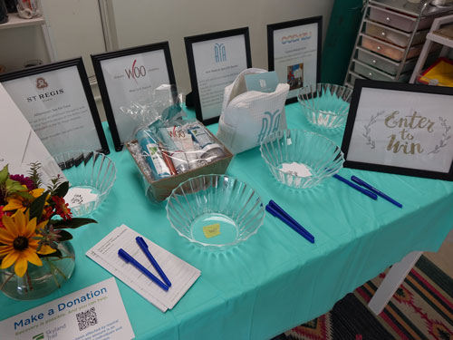 a table at the Skyland Trailblazers event with sign-up sheets and gift packages
