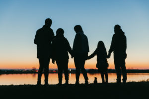 Silhouette of family at dusk on the beach