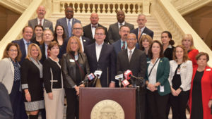 A group of mental health advocates stand together on the steps inside the Georgia Capitol on January 26, 2022.