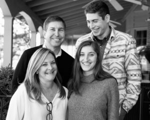 a black and white photo of a smiling family