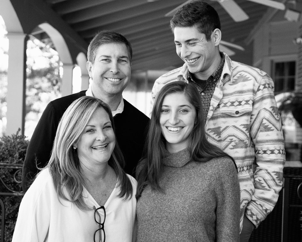 a black and white image of a smiling family