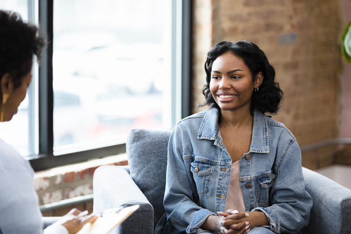 young Black woman participating in psychotherapy with a Black female psychiatrist