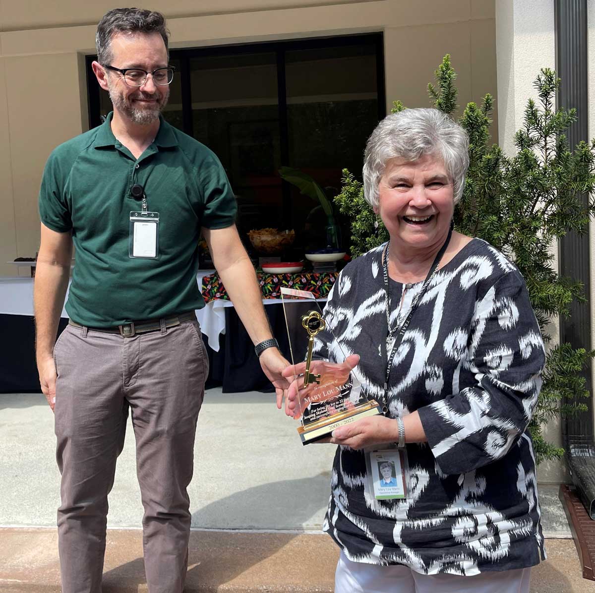 Mary Lou receiving retirment award from Chris Cline