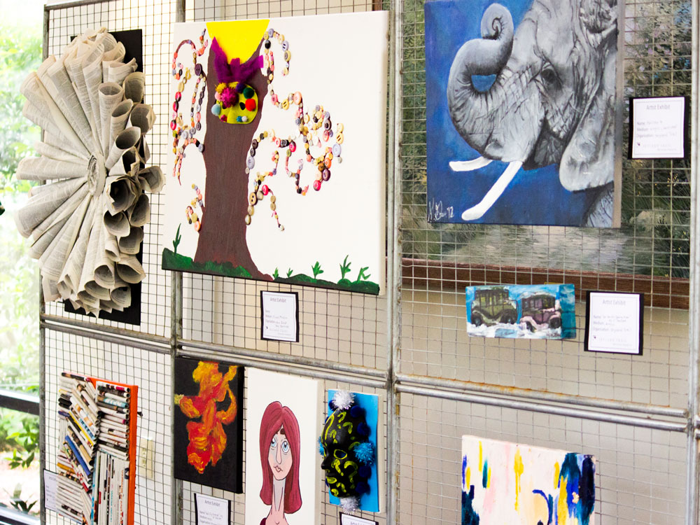 a photo of various artworks on display at the Arts in the Garden Artist Exhibit
