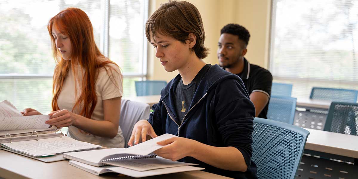 three adults in classroom for psychoeducation group as part of mental health intensive outpatient program