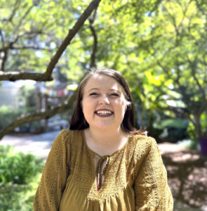 Skyland Trail adult residential treatment program graduate Lauren stands in garden smiling
