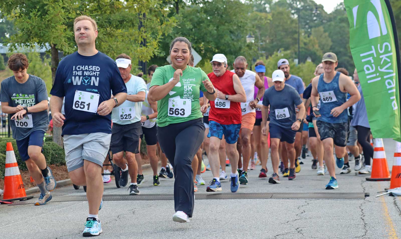 Group of runners cross the starting line at the Skyland Trail 5K run/walk for mental health treatment