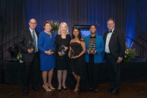 6 individuals standing holding awards