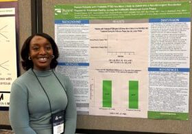 Woman standing in front of research poster