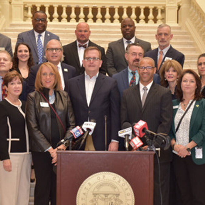 A group of mental health advocates stand together on the steps inside the Georgia Capitol on January 26, 2022.