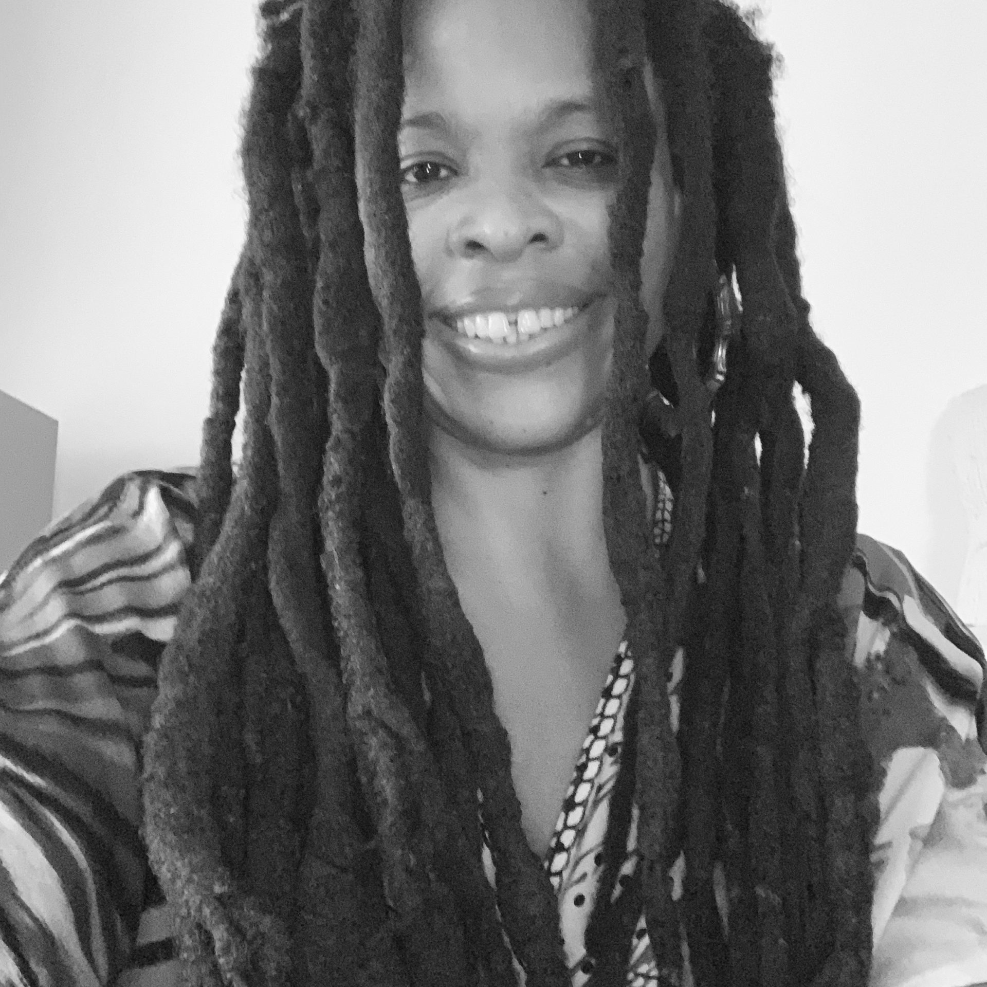 portrait of Nanette, a smiling black woman with locks